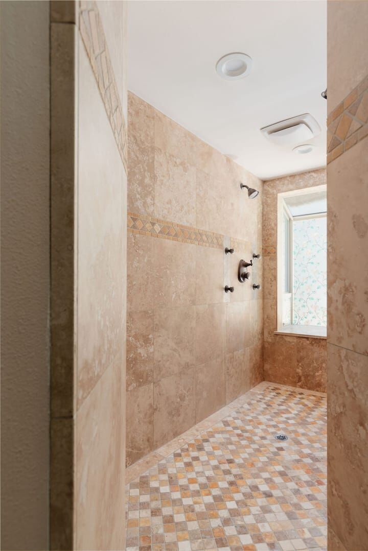 Walk-in travertine shower